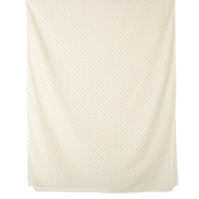 The Polka Dot scarf in cream, featuring a subtle spotty print, perfect for dressing up an outfit.